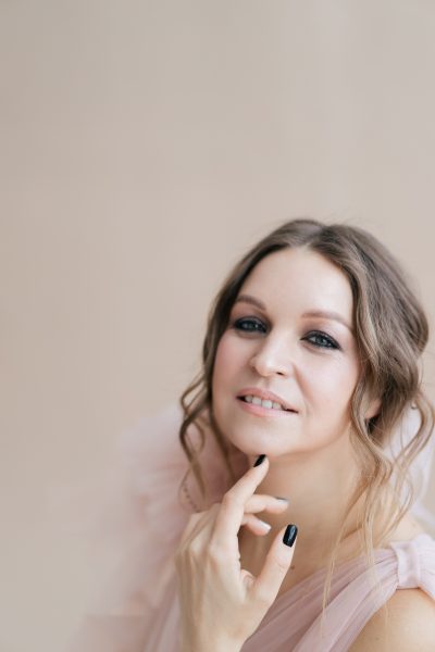 woman-close-up-portrait-photo-beige-studio-background-happy-smiley-face-2.jpg
