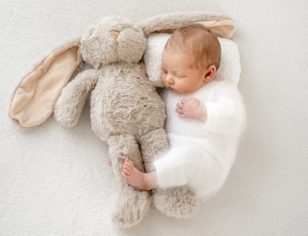 baby-newborn-photoshoot-first-days-life-lays-peacefully-soft-bunny-toy.jpg