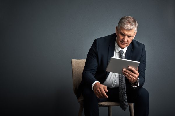 mature-man-tablet-attorney-studio-review-case-report-with-mockup-space-gray-background-person-corporate-lawyer-advisor-with-app-feedback-tech-with-virtual-consultation.jpg