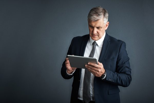 man-tablet-attorney-studio-with-scroll-report-case-with-mockup-space-gray-background-mature-person-corporate-lawyer-advisor-with-app-feedback-tech-with-virtual-consultation.jpg