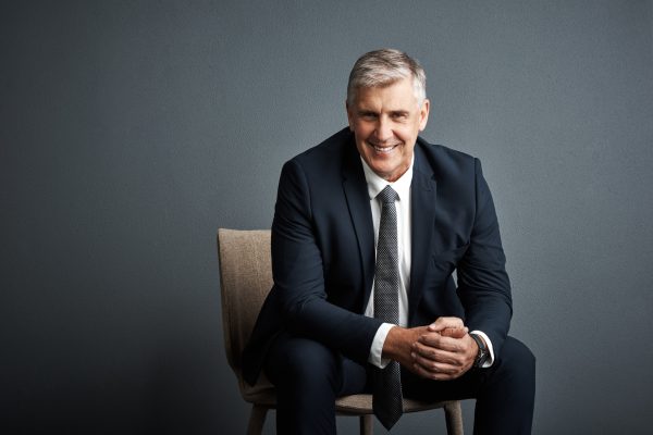 portrait-investor-man-chair-smile-career-ambition-dark-studio-background-mature-person-space-financial-advisor-with-pride-confidence-about-us-trading-company-mission.jpg