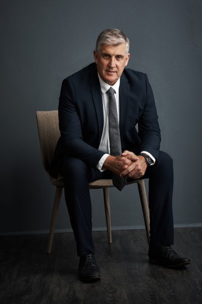 portrait-financial-advisor-man-studio-chair-professional-with-grey-background-mature-person-employee-investor-with-career-ambition-about-us-confidence-business-growth.jpg
