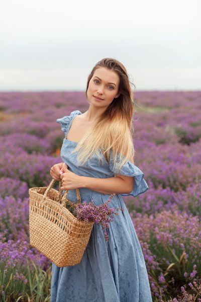 blonde-woman-rain-lavender-field-provence-gathering-flowers-into-wicker-bag.jpg