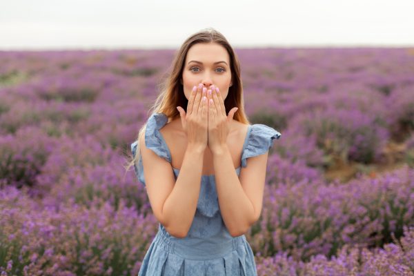 lang-hair-blonde-woman-sending-kisses-lavender-field-blue-dress-rain.jpg