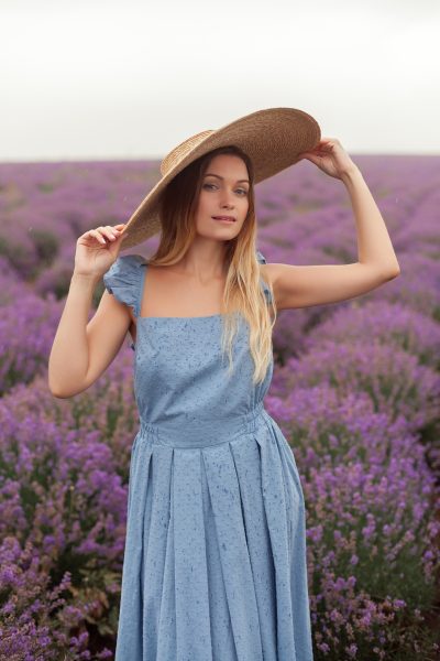 blonde-woman-round-wicker-hat-blue-dress-rain-lavender-field-4.jpg