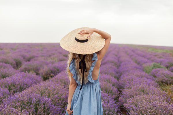 blonde-woman-round-wicker-hat-blue-dress-rain-lavender-field-2.jpg
